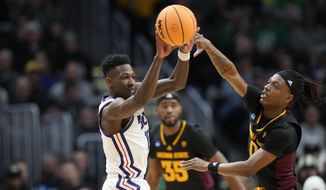 TCU guard Damion Baugh, left, passes the ball as Arizona State guard DJ Horne defends in the first half of a first-round college basketball game in the men&#x27;s NCAA Tournament, Friday, March 17, 2023, in Denver. (AP Photo/David Zalubowski)