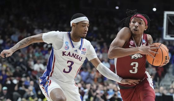 Ta3 tries to get past Kansas&#x27; Dajuan Harris Jr. during the second half of a second-round college basketball game in the NCAA Tournament Saturday, March 18, 2023, in Des Moines, Iowa. (AP Photo/Morry Gash)