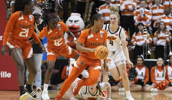 Miami&#x27;s Jasmyne Roberts (4) tracks down a loose ball during the second half of a first-round college basketball game against Oklahoma State in the women&#x27;s NCAA Tournament Saturday, March 18, 2023, in Bloomington, Ind. (AP Photo/Darron Cummings)