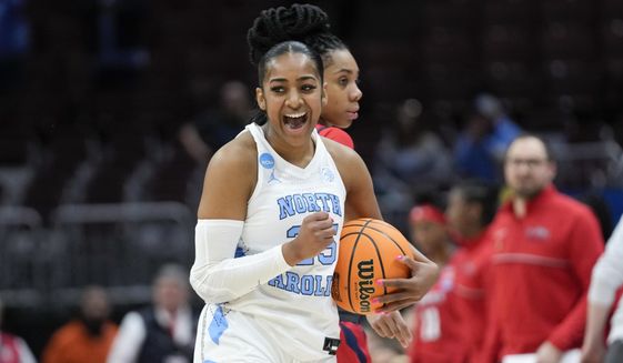 North Carolina guard Deja Kelly (25) reacts after beating St. John&#x27;s 61-59 in a first-round women&#x27;s college basketball game in the NCAA Tournament Saturday, March 18, 2023, in Columbus, Ohio. (AP Photo/Paul Sancya)