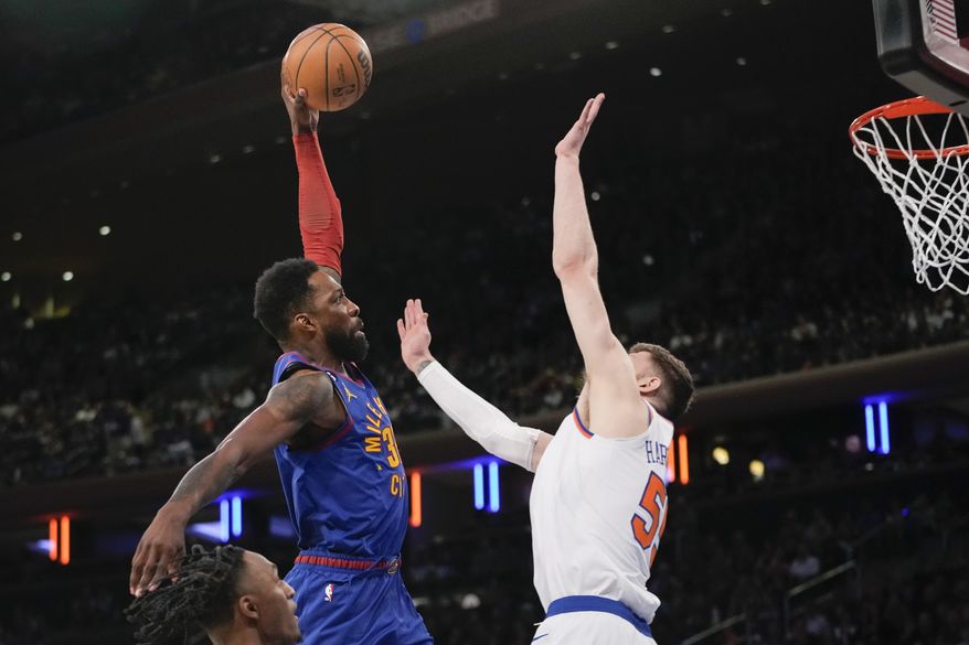 Denver Nuggets forward Jeff Green, left, goes to the basket as New York Knicks center Isaiah Hartenstein (55) defends during the first half of an NBA basketball game, Saturday, March 18, 2023, at Madison Square Garden in New York. (AP Photo/Mary Altaffer)
