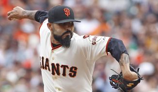San Francisco Giants pitcher Sergio Romo throws to the Colorado Rockies during the eighth inning of a baseball game, Saturday, June 27, 2015, in San Francisco. Sergio Romo will retire as a member of the San Francisco Giants after helping the franchise win three World Series titles. He&#x27;ll officially retire during San Francisco&#x27;s final exhibition game on March 27, 2023 when the Giants host the A&#x27;s at Oracle Park.(AP Photo/George Nikitin, File)