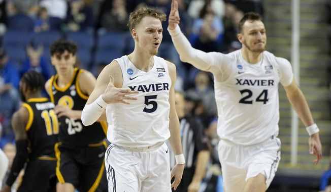 Xavier guard Adam Kunkel celebrates after scoring against Pittsburgh during the first half of a second-round college basketball game in the NCAA Tournament on Sunday, March 19, 2023, in Greensboro, N.C. (AP Photo/Chris Carlson)