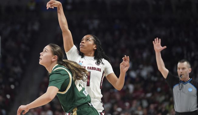 South Carolina guard Zia Cooke (1) follows through on a 3-point basket against South Florida guard Aerial Wilson (22) during the first half in a second-round college basketball game in the NCAA Tournament, Sunday, March 19, 2023, in Columbia, S.C. (AP Photo/Sean Rayford)