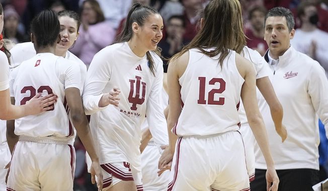 Indiana&#x27;s Mackenzie Holmes, middle, greets Yarden Garzon (12) during a timeout in the second half of a first-round college basketball game against Tennessee Tech in the women&#x27;s NCAA Tournament Saturday, March 18, 2023, in Bloomington, Ind. (AP Photo/Darron Cummings)