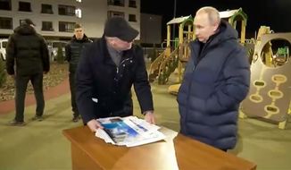 In this photo taken from video released by Russian Presidential Press Office on Sunday, March 19, 2023, Russian President Vladimir Putin, right, listens to Russian Deputy Prime Minister Marat Khusnullin at a newly built neighborhood during their visit to Mariupol in Russian-controlled Donetsk region, Ukraine. Putin has traveled to Crimea to mark the ninth anniversary of the Black Sea peninsula&#x27;s annexation from Ukraine. (Russian Presidential Press Office via AP)