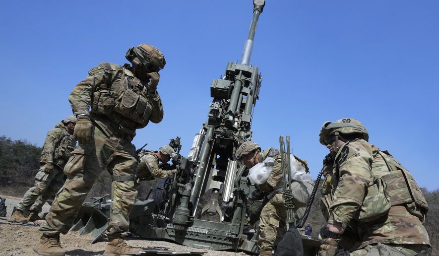 U.S. Army soldiers work on a M777 howitzer during a joint military drill between South Korea and the United States at Rodriguez Live Fire Complex in Pocheon, South Korea, Sunday, March 19, 2023. North Korea launched a short-range ballistic missile toward the sea on Sunday, its neighbors said, ramping up testing activities in response to U.S.-South Korean military drills that it views as an invasion rehearsal. (AP Photo/Ahn Young-joon)