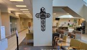 A cross depicting the emblems of five U.S. military branches was removed from the lobby of the Austin, Texas, Veterans Affairs department clinic following a watchdog group’s complaint. (Military Religious Freedom Foundation photo, used with permission)