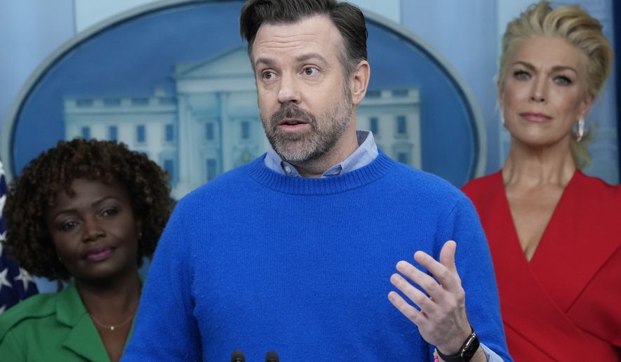 Jason Sudeikis, who plays the title character in the Apple TV+ series “Ted Lasso”, center, speaks during the daily press briefing with White House press secretary Karine Jean-Pierre, left, and fellow cast member Hannah Waddingham, right, at the White House in Washington, Monday, March 20, 2023. (AP Photo/Susan Walsh)
