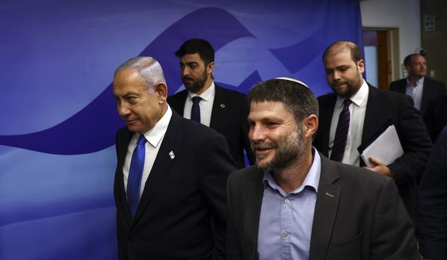 Israeli Prime Minister Benjamin Netanyahu, left, and Finance Minister Bezalel Smotrich, right, arrive to attend a Cabinet meeting at the Prime Minister&#x27;s office in Jerusalem, Feb. 23, 2023. The ultranationalist member of Israel&#x27;s ruling coalition says there&#x27;s no such thing as a Palestinian people. Finance Minister Smotrich&#x27;s remark Sunday, March 19, came within hours of efforts to calm tensions between Israel and the Palestinians over the country&#x27;s contentious plan to overhaul the judiciary. (Ronen Zvulun/Pool Photo via AP, File)