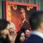 A poster of the late Lance Reddick, a cast member in &quot;John Wick: Chapter 4,&quot; hangs on a backdrop at the premiere of the film, Monday, March 20, 2023, at the TCL Chinese Theatre in Los Angeles. The veteran character actor Reddick died early Friday at age 60. (AP Photo/Chris Pizzello)