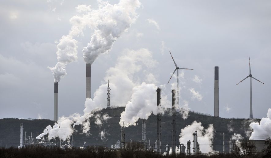 The industrial backdrop of a BP refinery and a Uniper coal-fired power plant is seen in Gelsenkirchen, Germany, March 6, 2023. A major new United Nations report being released Monday, March 20, 2023, is expected to provide a sobering reminder that time is running out if humanity wants to avoid passing a dangerous global warming threshold. (AP Photo/Martin Meissner, File)