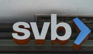 The Silicon Valley Bank logo is seen at an open branch in Pasadena, Calif., on March 13, 2023. (AP Photo/Damian Dovarganes, File)