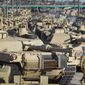 A soldier walks past a line of M1 Abrams tanks, Nov. 29, 2016, at Fort Carson in Colorado Springs, Colo. U.S. officials say the Pentagon is speeding up its delivery of Abrams tanks to Ukraine, opting to send a refurbished older model that can be ready faster. The aim is to get the 70-ton battle powerhouses to the war zone in eight to 10 months. (Christian Murdock/The Gazette via AP, File)