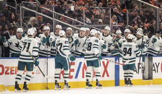 San Jose Sharks celebrate after a goal against the Edmonton Oilers during first-period NHL hockey game action in Edmonton, Alberta, Monday, March 20, 2023. (Jason Franson/The Canadian Press via AP)