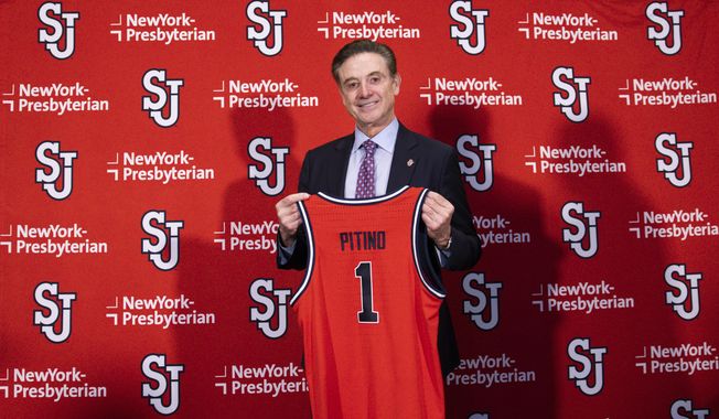 New St. John&#x27;s NCAA college basketball head coach Rick Pitino holds up a jersey after being introduced during a news conference at Madison Square Garden in New York, Tuesday, March 21, 2023. (AP Photo/Corey Sipkin)