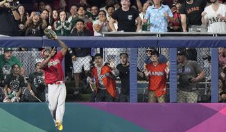 Mexico left fielder Randy Arozarena catches a ball hit by Japan&#x27;s Kensuke Kondoh during the fifth inning of a World Baseball Classic game, Monday, March 20, 2023, in Miami. (AP Photo/Wilfredo Lee)