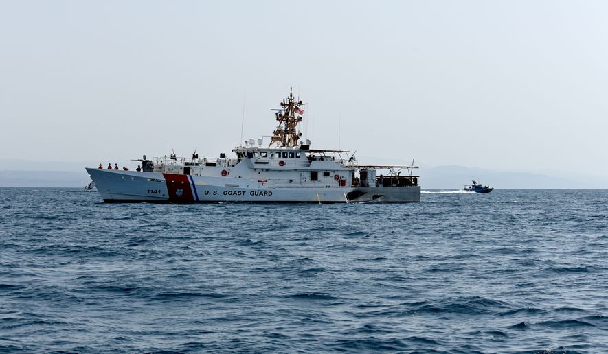 A 34-foot Dauntless-class patrol boat assigned to Maritime Expeditionary Security Squadron Eleven keeps watch over Charles Moulthrope, Coast Guard Patrol Craft. (U.S. Navy photo by  Mass Communication Specialist 1st Class Randi Brown)