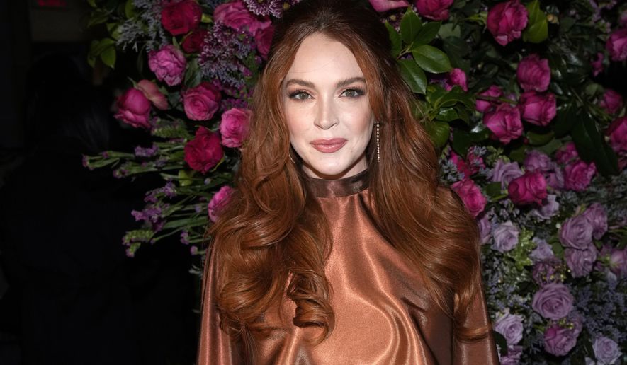Actress Lindsay Lohan appears at the Christian Siriano Fall/Winter 2023 fashion show in New York, Feb. 9, 2023. The Securities and Exchange Commission said Wednesday, March 22, that Lohan, rapper Akon and several other celebrities have agreed to pay tens of thousands of dollars to settle claims that they promoted crypto investments to their millions of social media followers without disclosing they were being paid to do so. (Photo by Charles Sykes/Invision/AP, File)