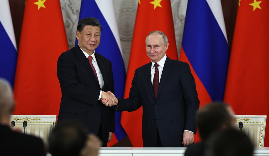 Russian President Vladimir Putin, right, and Chinese President Xi Jinping shake hands after speaking to the media during a signing ceremony following their talks at The Grand Kremlin Palace, in Moscow on March 21, 2023. Xi just concluded his three-day visit with Putin, a warm affair in which the two men praised each other and spoke of a profound friendship. It&#x27;s a high in a complicated, centuries-long relationship in which the two countries have been allies and enemies. (Mikhail Tereshchenko, Sputnik, Kremlin Pool Photo via AP) **FILE**