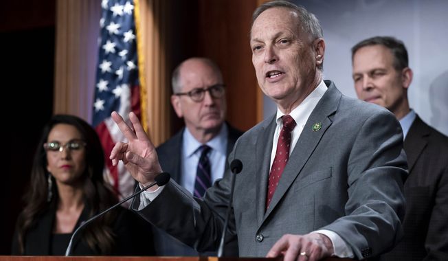 Rep. Andy Biggs, R-Ariz., joined by other members of the conservative House Freedom Caucus, speaks at a news conference on the debt limit, at the Capitol in Washington, Wednesday, March 22, 2023. (AP Photo/J. Scott Applewhite)