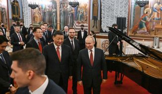 Chinese President Xi Jinping, center left, and Russian President Vladimir Putin, right, walk after their dinner at The Palace of the Facets in the Moscow Kremlin, Russia, Tuesday, March 21, 2023. (Grigory Sysoyev, Sputnik, Kremlin Pool Photo via AP)