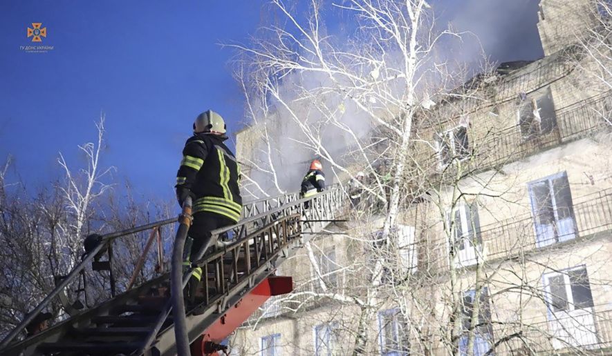 In this photo provided by the Ukrainian Emergency Service, emergency personnel work at the scene following a drone attack in the town of Rzhyshchiv, Kyiv region, Ukraine, Wednesday, March 22, 2023. (Ukrainian Emergency Service via AP Photo)