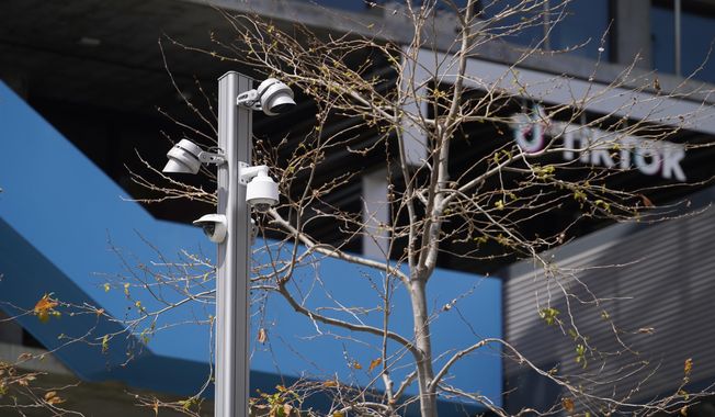 Security cameras are seen at the TikTok Inc. building in Culver City, Calif., Friday, March 17, 2023. (AP Photo/Damian Dovarganes, File)