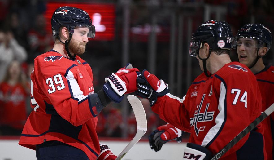 Washington Capitals right wing Anthony Mantha (39) celebrates after his goal with defenseman John Carlson (74) during the first period of an NHL hockey game against the Chicago Blackhawks, Thursday, March 23, 2023, in Washington. (AP Photo/Nick Wass)