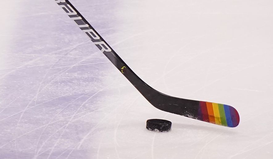 Florida Panthers center Eetu Luostarinen uses a stick with the LGBT pride flag on it before the start of an NHL hockey game against the Nashville Predators during Pride Day, Saturday, March 20, 2021, in Sunrise, Fla. The Chicago Blackhawks will not wear Pride-themed warmup jerseys before Sunday&#x27;s Pride Night game against Vancouver because of security concerns involving a Russian law that expands restrictions on activities seen as promoting LGBTQ rights in the country. (AP Photo/Wilfredo Lee, File) **FILE**