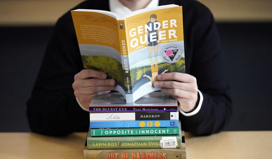 A pile of challenged books appear at the Utah Pride Center in Salt Lake City on Dec. 16, 2021. Attempted book bannings and restrictions at school and public libraries continue to surge, according to a new report from the American Library Association. (AP Photo/Rick Bowmer, File)