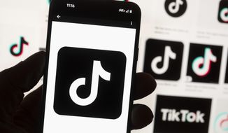 The TikTok logo is seen on a cellphone on Oct. 14, 2022, in Boston. China’s government said Thursday, March 23, 2023, it would oppose possible U.S. plans to force TikTok’s Chinese owner to sell the short-video service as a security risk and warned such a move would hurt investor confidence in the United States. (AP Photo/Michael Dwyer, File)