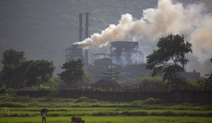Smoke rises from a coal-powered steel plant at Hehal village near Ranchi, in eastern state of Jharkhand, Sept. 26, 2021. India will require $900 billion over the next 30 years to move away from coal mines and thermal plants, a New Delhi-based think tank said in a report Thursday, March 23, 2023. (AP Photo/Altaf Qadri) **FILE**