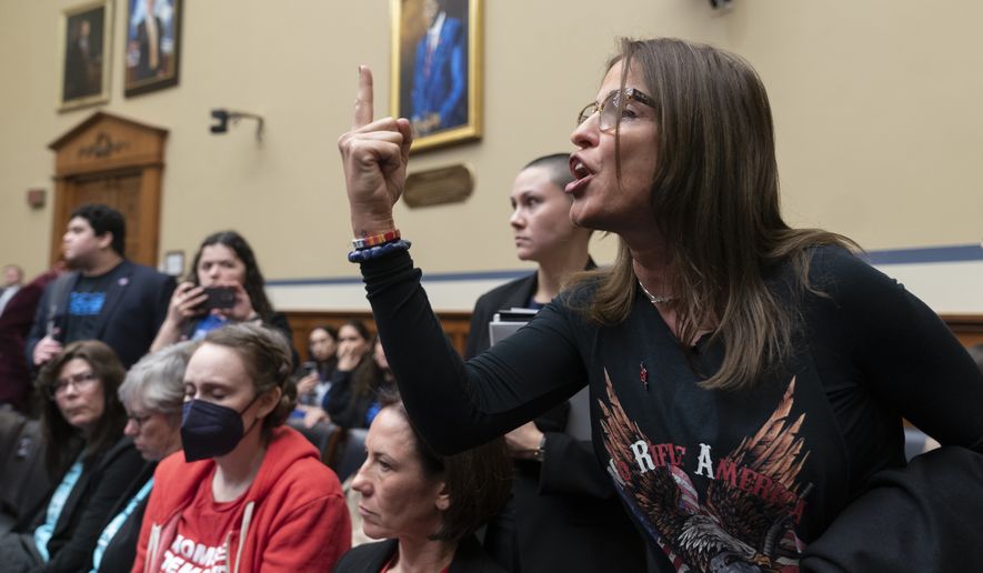 Patricia Oliver, the mother of Joaquin Oliver, one of the victims of the 2018 mass shooting at Marjory Stoneman Douglas High School in Parkland, Fla., argues with lawmakers during a hearing recess on Capitol Hill in Washington, Thursday, March 23, 2023. (AP Photo/Manuel Balce Ceneta)