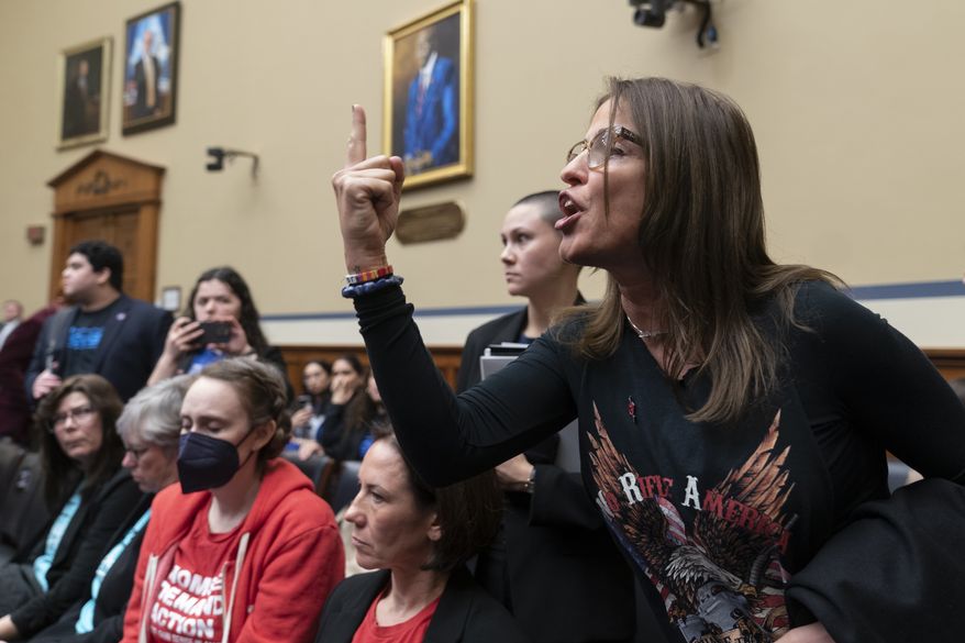 Patricia Oliver, the mother of Joaquin Oliver, one of the victims of the 2018 mass shooting at Marjory Stoneman Douglas High School in Parkland, Fla., argues with lawmakers during a hearing recess on Capitol Hill in Washington, Thursday, March 23, 2023. (AP Photo/Manuel Balce Ceneta)