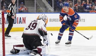 Arizona Coyotes goalie Connor Ingram (39) makes the save on Edmonton Oilers&#x27; Connor McDavid (97) during the second period of an NHL hockey game in Edmonton, Alberta, Wednesday, March 22, 2023. (Jason Franson/The Canadian Press via AP)