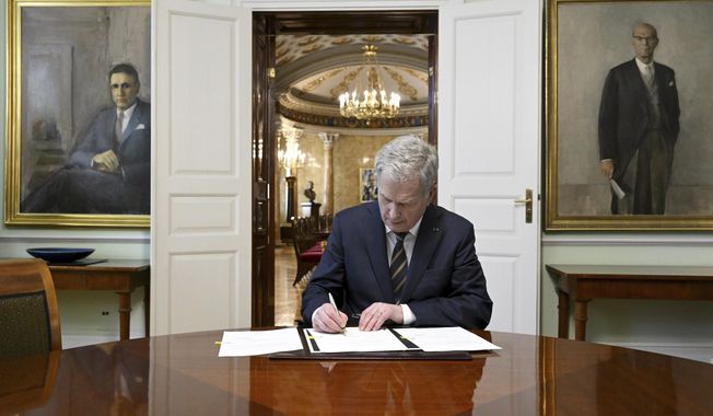 Finland&#x27;s President Sauli Niinisto signs Finland&#x27;s national Nato legislation in Helsinki, Finland, Thursday March 23, 2023. The Finnish president has sealed the Nordic country’s historic bid to join NATO by signing into laws the required legal amendments needed for membership in the military alliance. The president&#x27;s move Thursday means Finland is now awaiting approval from Turkey and Hungary, the only two of NATO’s 30 existing members that haven’t ratified its bid. (Markku Ulander/Lehtikuva via AP)