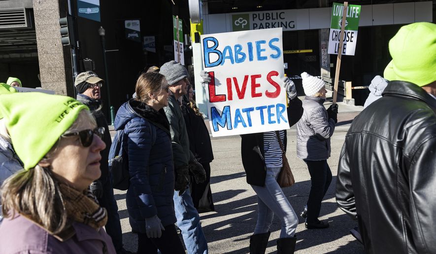 People walk to the Idaho Capitol Building for the Boise March for Life rally, Saturday, Jan. 21, 2023. A rural hospital in Sandpoint, Idaho, will stop delivering babies, citing recently passed state laws criminalizing medical care, among other reasons. (Sarah A. Miller/Idaho Statesman via AP,File)