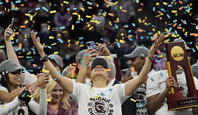 South Carolina head coach Dawn Staley celebrates after beating UConn, 64-49, to win the championship game of the NCAA college basketball Final Four in Minneapolis, Sunday, April 3, 2022. Women’s college basketball believes it has the makings for a hit reality TV show. Those engaged in the sport hope to give network execs another glimpse this weekend of why they need to ante up during March Madness. (AP Photo/Eric Gay) **FILE**