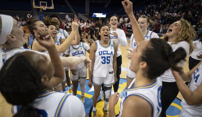 UCLA players celebrate after defeating Oklahoma in a second-round college basketball game in the NCAA Tournament, Monday, March 20, 2023, in Los Angeles. UCLA won, 82-73. (AP Photo/Kyusung Gong)