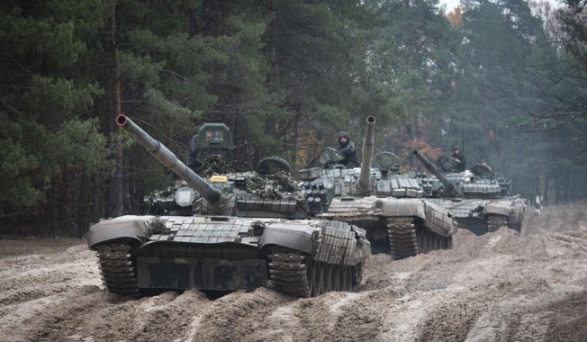 Ukrainian soldiers on captured Russian tanks T-72 hold military training close to the Ukraine-Belarus border near Chernihiv, Ukraine, Friday, Oct. 28, 2022. (AP Photo/Aleksandr Shulman, File)