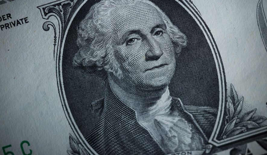 The likeness of George Washington is seen on a U.S. one dollar bill, Monday, March 13, 2023, in Marple Township, Pa. (AP Photo/Matt Slocum)