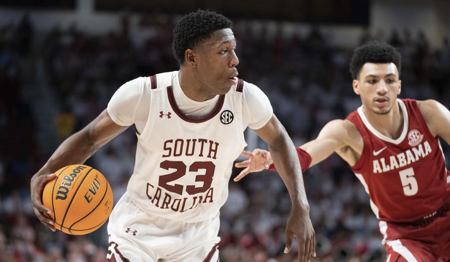 South Carolina forward Gregory Jackson II (23) is defended by Alabama guard Jahvon Quinerly (5) during the second half of an NCAA college basketball game Wednesday, Feb. 22, 2023, in Columbia, S.C. Alabama won 78-76 in overtime. (AP Photo/Sean Rayford)