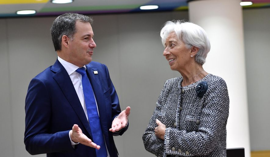 European Central Bank President Christine Lagarde, right, speaks with Belgium&#x27;s Prime Minister Alexander De Croo during a round table meeting at an EU summit in Brussels, Friday, March 24, 2023. European leaders gather Friday to discuss economic and financial challenges and banking rules, seeking to tamp down concerns about eventual risks for European consumers from banking troubles in the US and Switzerland. (AP Photo/Geert Vanden Wijngaert)