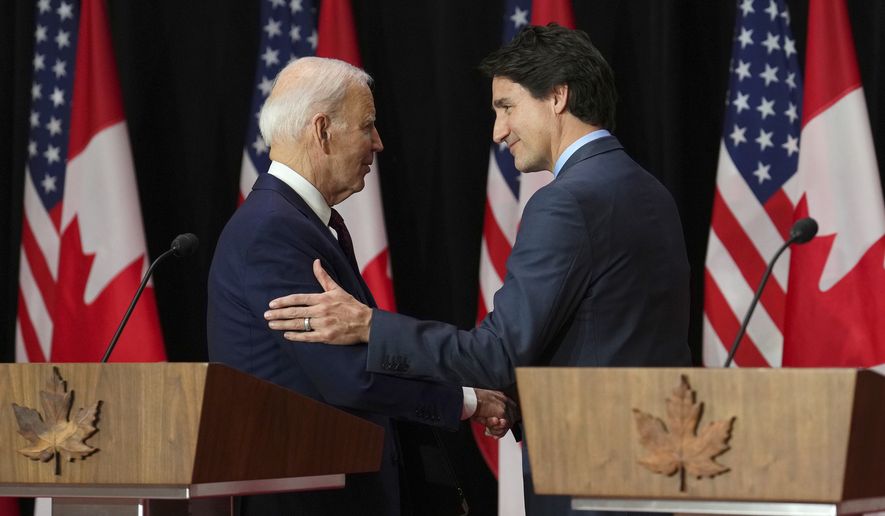 President Joe Biden and Canada Prime Minister Justin Trudeau embrace following in a joint news conference in Ottawa, Friday, March 24, 2023. (Sean Kilpatrick/The Canadian Press via AP)