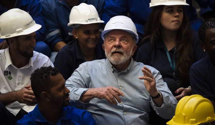 Brazil&#x27;s President Luiz Inacio Lula da Silva looks up after taking having a photo taken with workers during a visit to the reconstruction works of the National Museum in Rio de Janeiro, Brazil, Thursday, March 23, 2023. The museum and a large part of its collection were destroyed in a 2018 fire. (AP Photo/Bruna Prado)