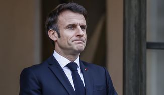 French President Emmanuel Macron awaits President of Costa Rica Rodrigo Chaves Robles for a meeting at the Elysee Palace in Paris, Friday, March 24, 2023. (AP Photo/Thomas Padilla)