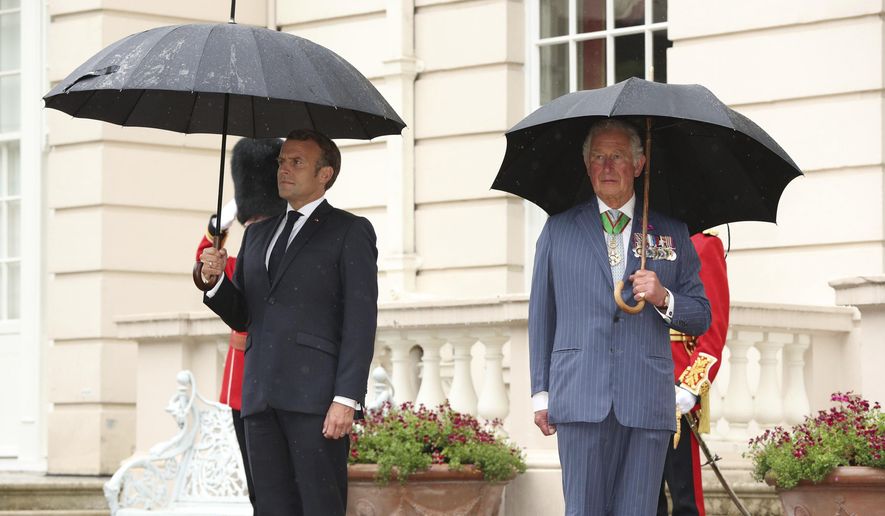 Britain&#x27;s Prince Charles welcomes French president Emmanuel Macron, left, to Clarence House in London, Thursday June 18, 2020. French President Emmanuel Macron’s office on Friday, March 24, 2023, said a state visit by Britain’s King Charles III has been postponed amid mass strikes and protests in France. The king had been scheduled to arrive in France on Sunday on his first state visit as monarch, before heading to Germany on Wednesday. (Jonathan Brady/Pool via AP, File)
