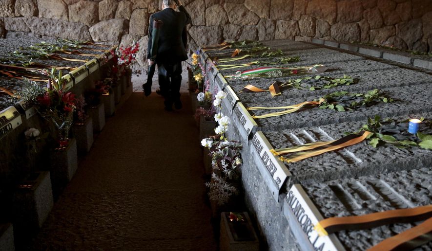 A man walks amid the graves of the 335 victims of one of the worst World War II-era massacres in German-occupied Italy at the Ardeatine Caves in Rome, on its 79th anniversary, Friday, March 24, 2023. 335 people were shot to death on March 24, 1944, as a reprisal for an attack by partisans that killed 33 Nazi soldiers on a street in Rome. (Cecilia Fabiano/LaPresse via AP)