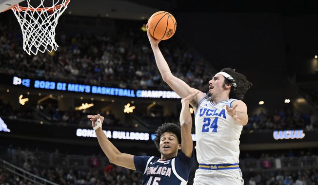 UCLA&#x27;s Jaime Jaquez Jr. (24) shoots while defended by Gonzaga&#x27;s Rasir Bolton (45) in the first half of a Sweet 16 college basketball game in the West Regional of the NCAA Tournament, Thursday, March 23, 2023, in Las Vegas. (AP Photo/David Becker)